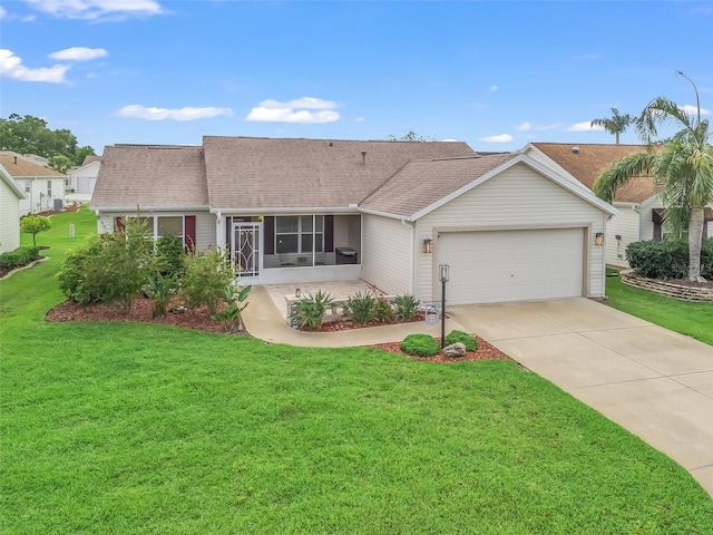 1307 Galindo Pl, The Villages, FL 32159 - ranch-style home featuring a sunroom, roof with shingles, a garage, and a front yard