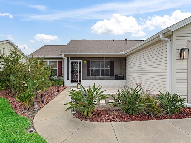 1307 Galindo Pl, The Villages, FL 32159 - view of exterior entry featuring a shingled roof