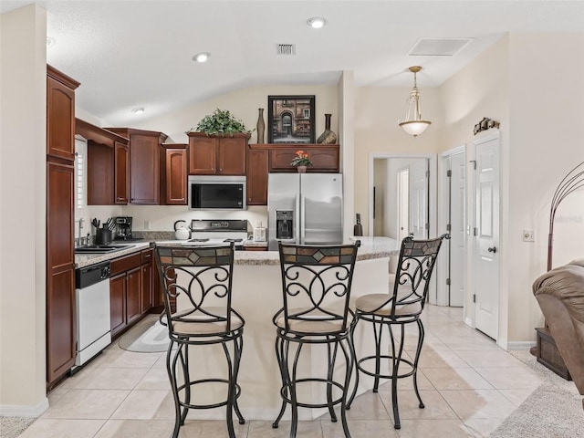 1307 Galindo Pl, The Villages, FL 32159 - kitchen featuring stainless steel fridge with ice dispenser, visible vents, light tile patterned floors, white dishwasher, and a breakfast bar