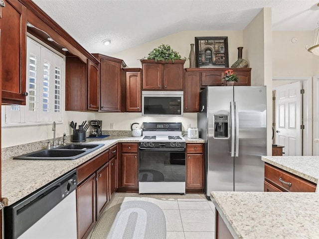 1307 Galindo Pl, The Villages, FL 32159 - kitchen featuring light tile patterned floors, light countertops, a textured ceiling, stainless steel appliances, and a sink