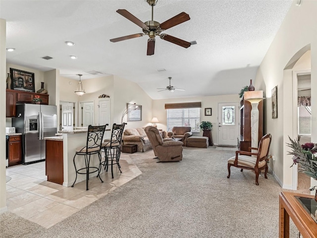 1307 Galindo Pl, The Villages, FL 32159 - living room with a textured ceiling, a ceiling fan, visible vents, arched walkways, and light colored carpet