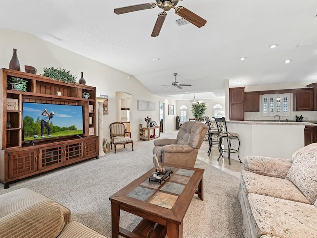 1307 Galindo Pl, The Villages, FL 32159 - living area featuring light carpet, ceiling fan, vaulted ceiling, and plenty of natural light