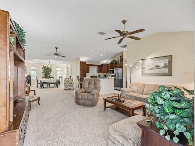 1307 Galindo Pl, The Villages, FL 32159 - living room featuring vaulted ceiling, a textured ceiling, visible vents, ceiling fan, and light colored carpet