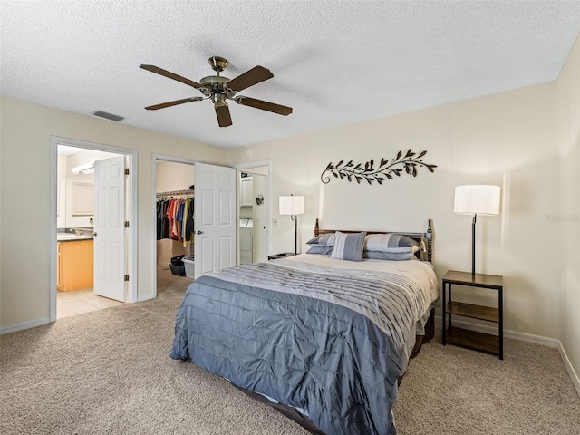 1307 Galindo Pl, The Villages, FL 32159 - bedroom with a spacious closet, visible vents, light colored carpet, and a textured ceiling
