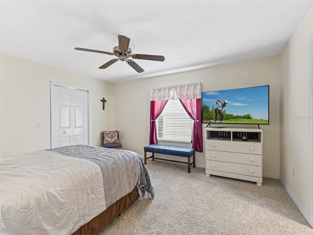 1307 Galindo Pl, The Villages, FL 32159 - carpeted bedroom featuring a textured ceiling, a closet, baseboards, and a ceiling fan