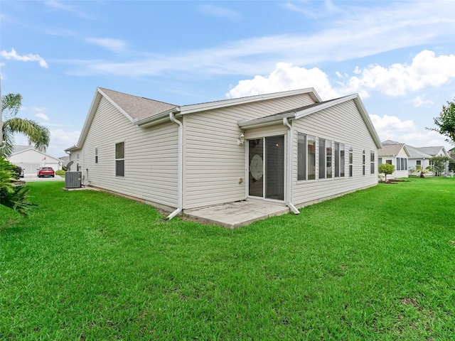 1307 Galindo Pl, The Villages, FL 32159 - rear view of property featuring cooling unit, a sunroom, and a lawn