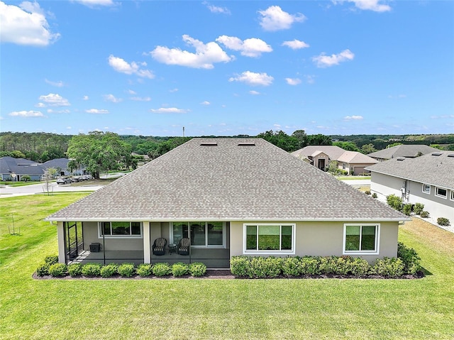 view of front of house with roof with shingles, stucco siding, and a front lawn