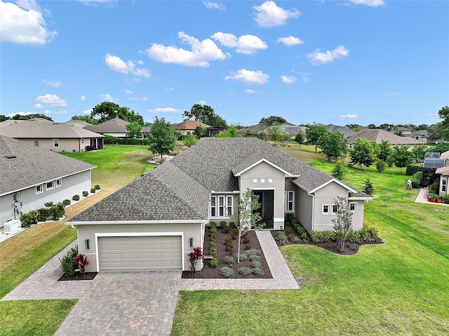 view of front of house with a residential view, stucco siding, decorative driveway, a front lawn, and a garage
