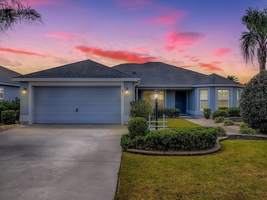 1346 Kilgore Way, The Villages, FL 32163 - single story home featuring a garage, concrete driveway, stucco siding, and a lawn