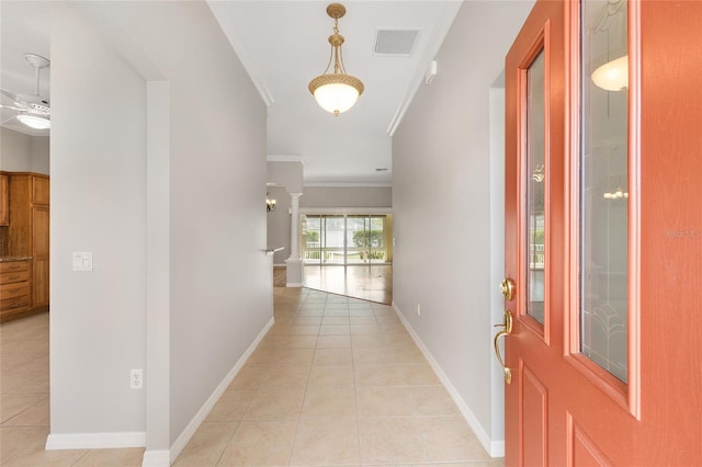 278 Matisse Ave, The Villages, FL 32162 - hallway featuring crown molding, ornate columns, visible vents, light tile patterned flooring, and baseboards