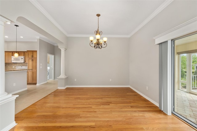 278 Matisse Ave, The Villages, FL 32162 - unfurnished dining area with light wood-type flooring, ornate columns, and ornamental molding