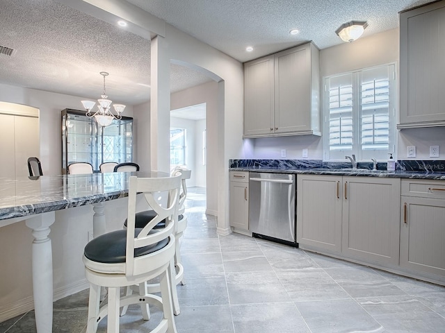 kitchen featuring gray cabinets, stainless steel dishwasher, and a textured ceiling