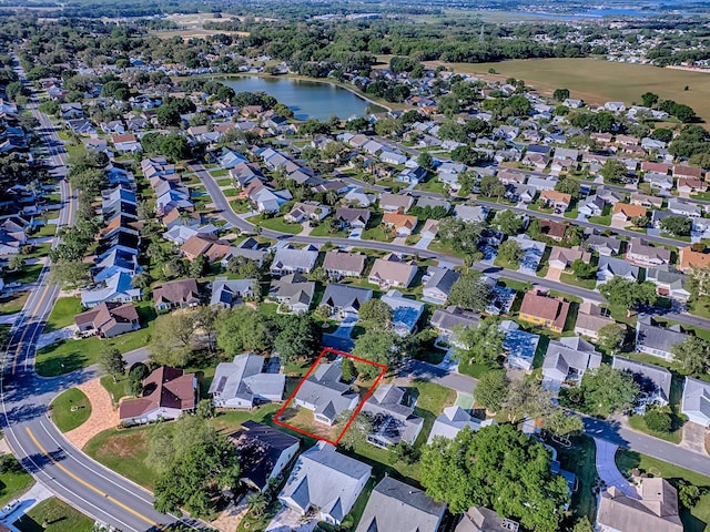 drone / aerial view featuring a water view and a residential view