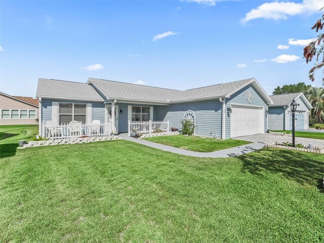 single story home featuring a porch, driveway, a garage, and a front lawn