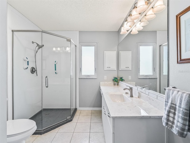 full bath featuring tile patterned floors, a stall shower, a wealth of natural light, and a textured ceiling