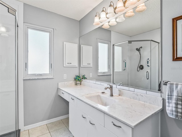 full bathroom with a shower stall, tile patterned floors, plenty of natural light, and a textured ceiling