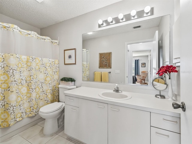 bathroom featuring a textured ceiling, vanity, tile patterned flooring, visible vents, and toilet
