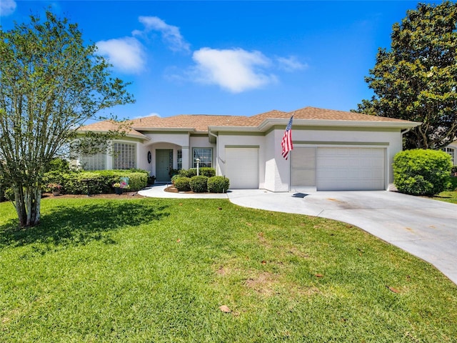 view of front of home featuring a front yard, an attached garage, concrete driveway, and stucco siding