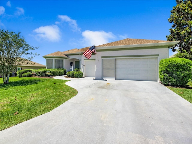 view of front of property with a garage, a front yard, stucco siding, and concrete driveway