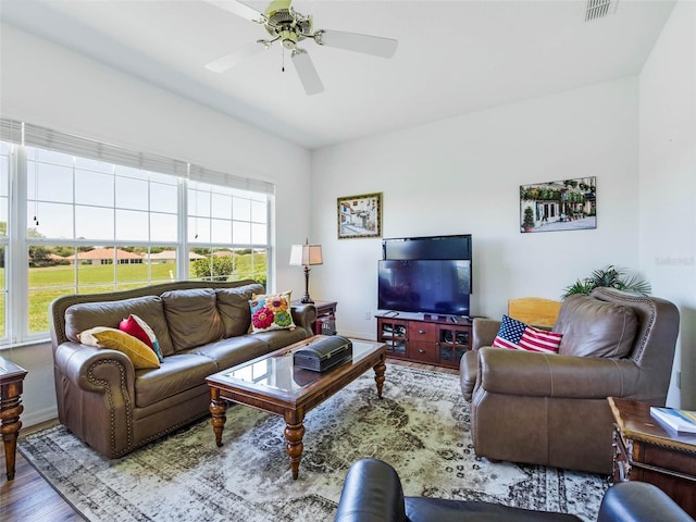 living room with wood finished floors, a ceiling fan, and visible vents