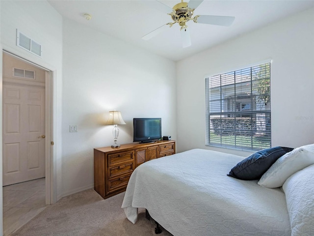 bedroom featuring visible vents, ceiling fan, light colored carpet, and baseboards