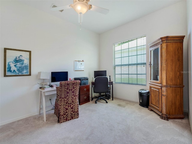 home office with light carpet, ceiling fan, and baseboards
