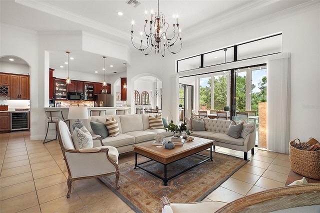 living room with crown molding, light tile patterned floors, arched walkways, and beverage cooler