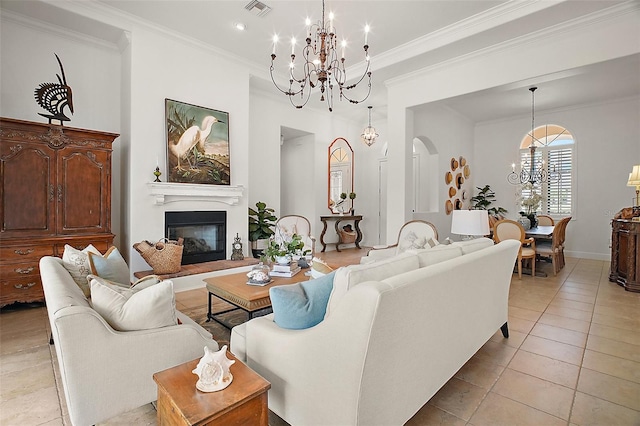living area with a glass covered fireplace, visible vents, an inviting chandelier, and light tile patterned flooring