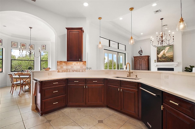 kitchen with an inviting chandelier, light countertops, visible vents, dishwasher, and a sink