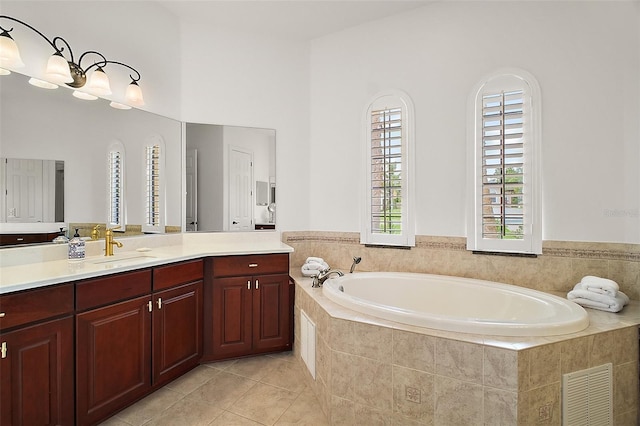 full bathroom featuring a garden tub, vanity, tile patterned flooring, and visible vents