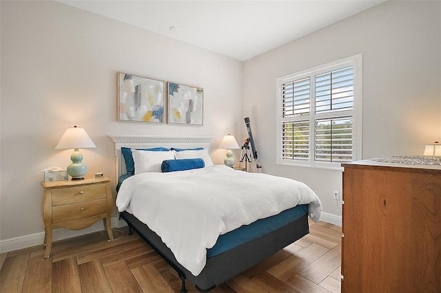 bedroom featuring baseboards and wood finished floors