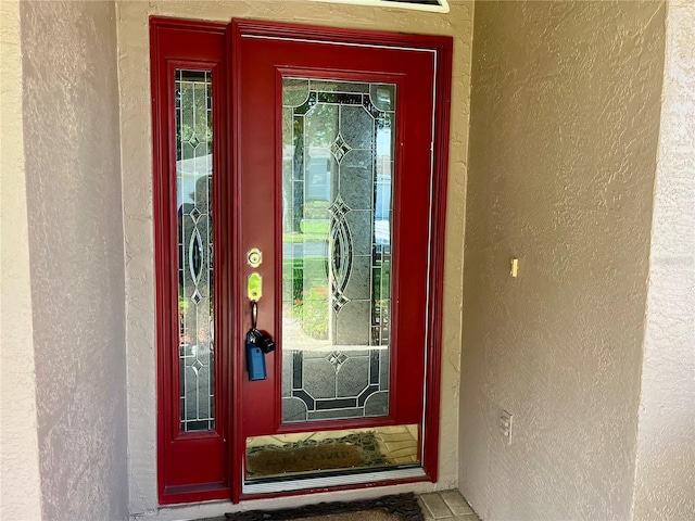 entrance to property with stucco siding
