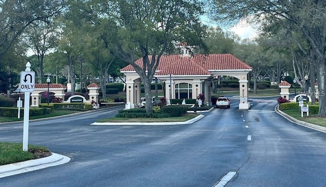 view of asphalt street with curbs