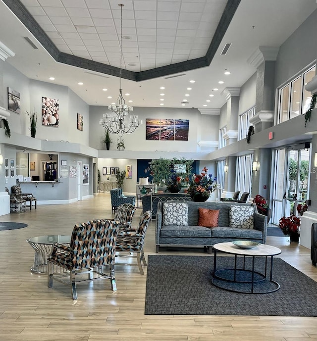 lobby with a high ceiling, crown molding, and recessed lighting