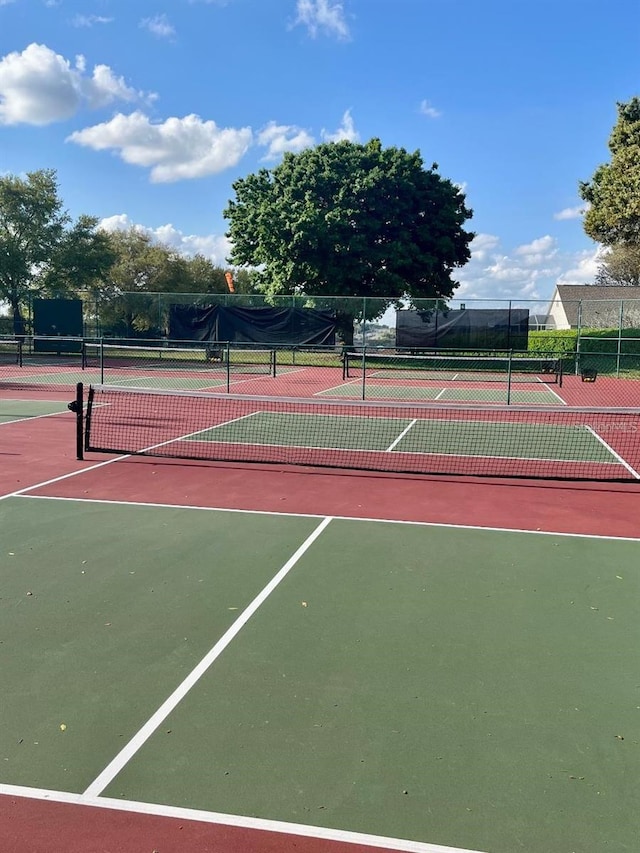 view of tennis court with fence and community basketball court