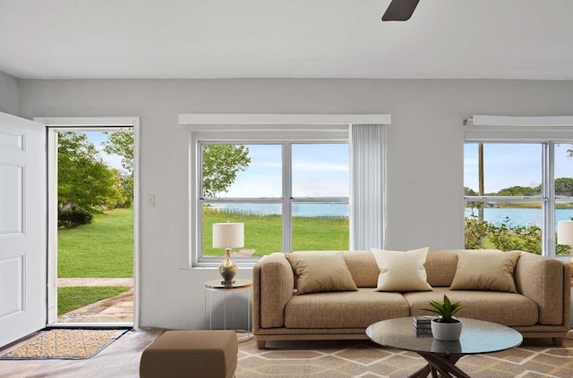 interior space featuring a water view and a ceiling fan