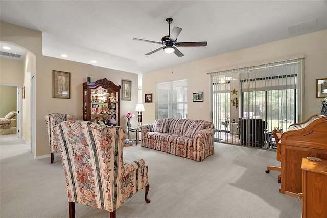 3828 Arbordale Ct, Leesburg, FL 34748 - living room featuring arched walkways, carpet flooring, a ceiling fan, and visible vents