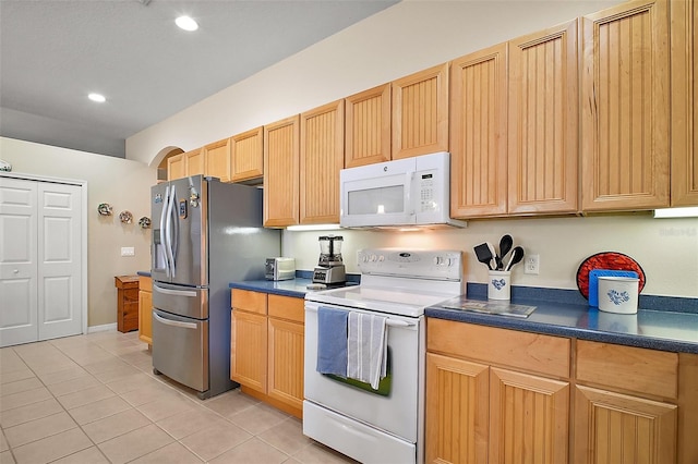 3828 Arbordale Ct, Leesburg, FL 34748 - kitchen featuring recessed lighting, white appliances, light tile patterned flooring, and dark countertops