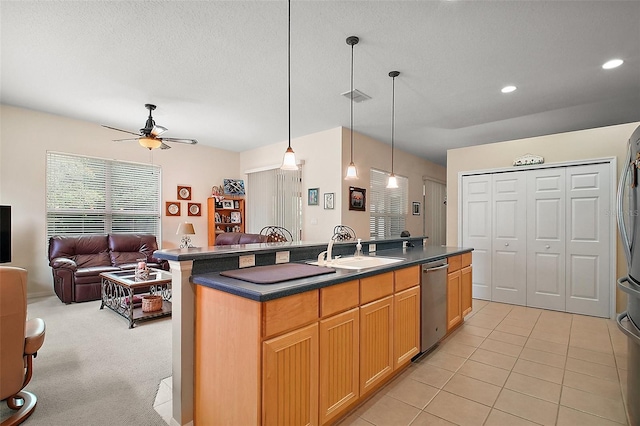 3828 Arbordale Ct, Leesburg, FL 34748 - kitchen featuring a sink, open floor plan, ceiling fan, dark countertops, and stainless steel appliances