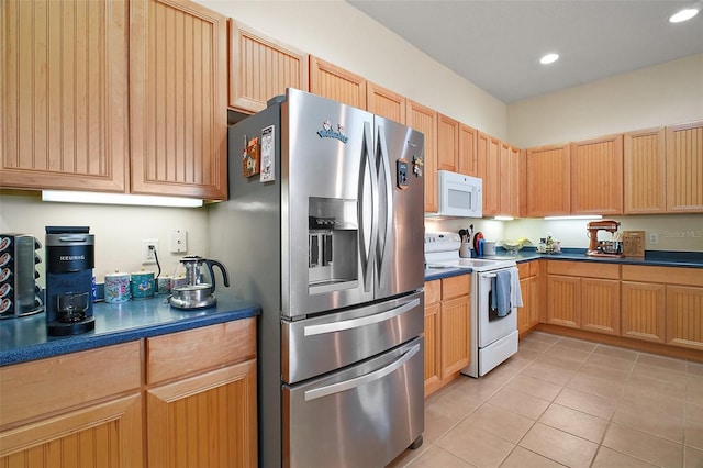 3828 Arbordale Ct, Leesburg, FL 34748 - kitchen with light tile patterned flooring, dark countertops, white appliances, and recessed lighting