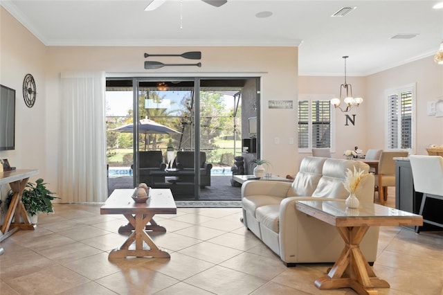 living area featuring crown molding, ceiling fan with notable chandelier, light tile patterned floors, and visible vents