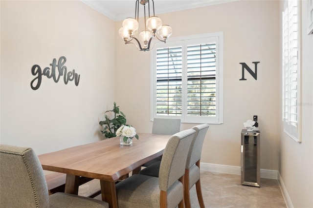 dining area featuring ornamental molding, baseboards, and an inviting chandelier