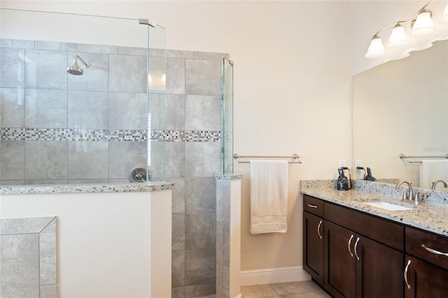 bathroom featuring baseboards, a walk in shower, and vanity