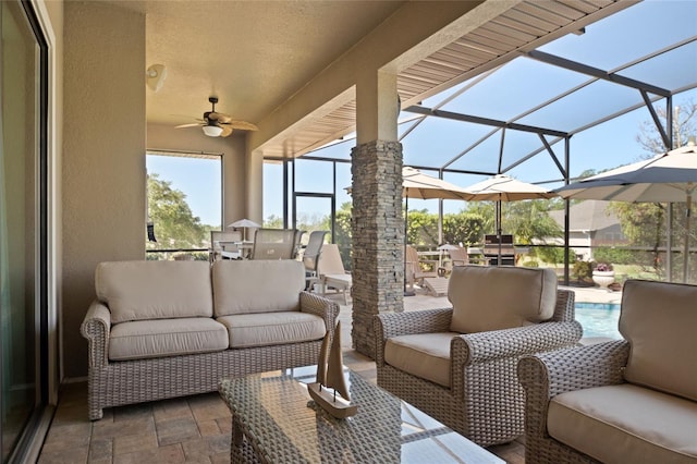 view of patio with outdoor lounge area, an outdoor pool, a ceiling fan, and glass enclosure