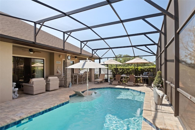 outdoor pool with an outdoor living space, glass enclosure, a patio, and area for grilling