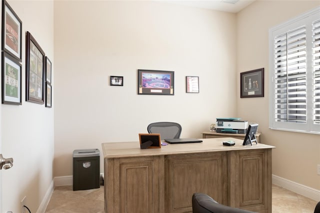 home office with baseboards and light tile patterned flooring