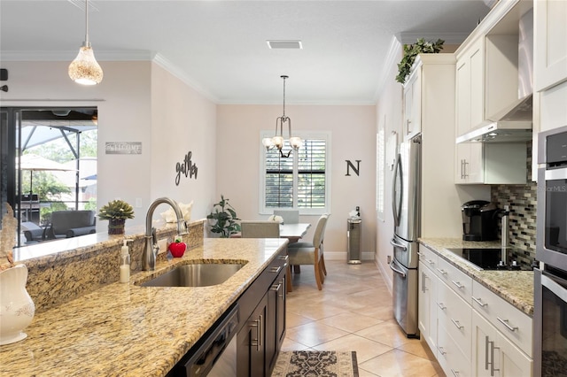 kitchen with a sink, a wealth of natural light, appliances with stainless steel finishes, and wall chimney exhaust hood