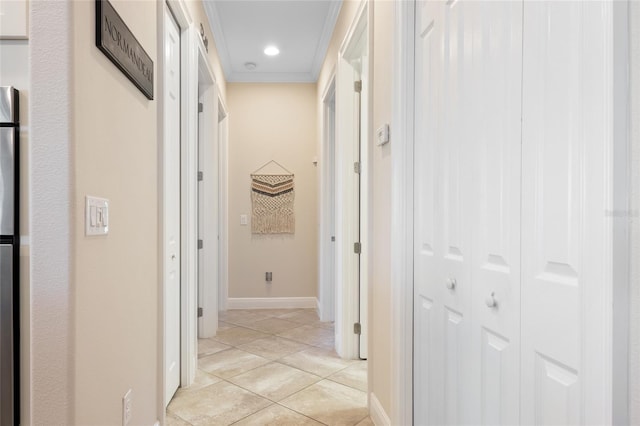 hall with recessed lighting, light tile patterned floors, baseboards, and ornamental molding