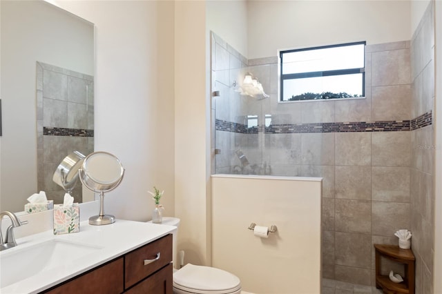 full bathroom featuring toilet, a walk in shower, and vanity