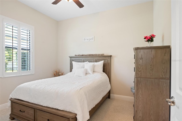 bedroom with light carpet, ceiling fan, and baseboards